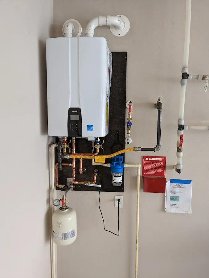 Professional plumber installing copper piping in a Clarkstown home